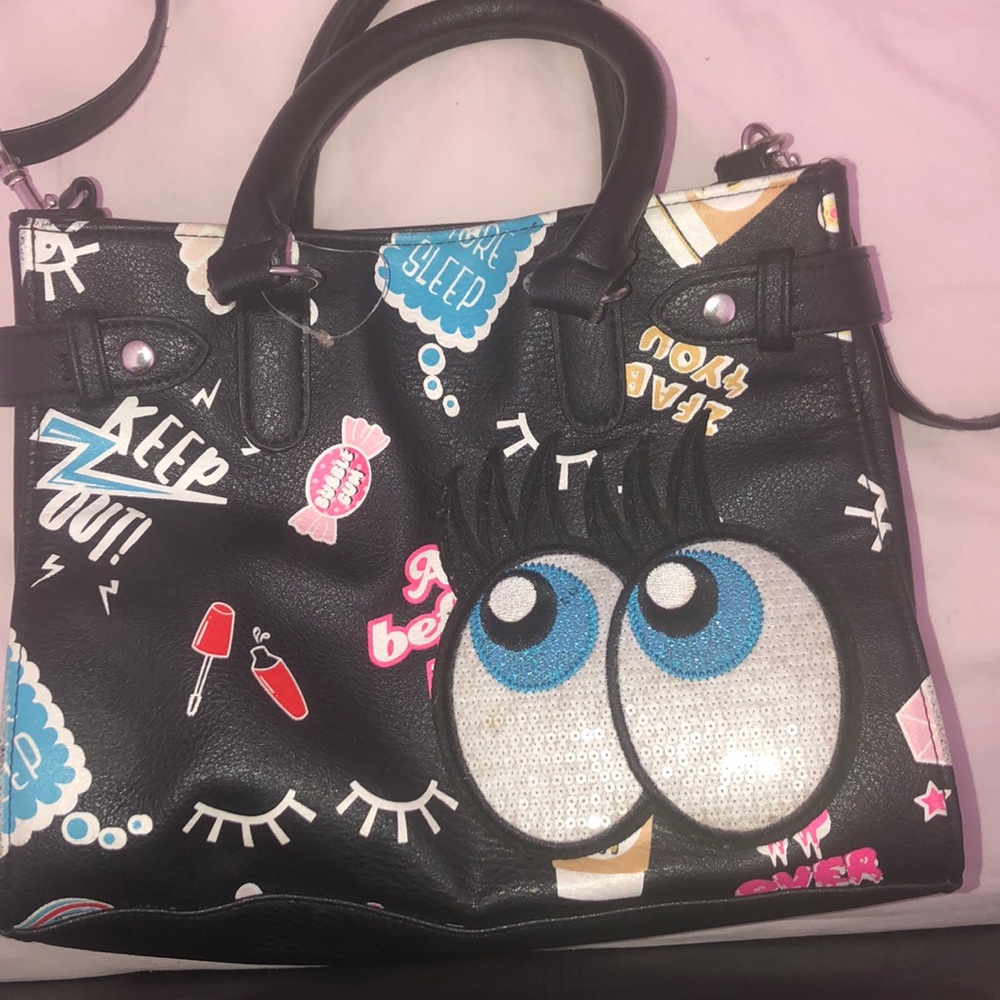 A black purse with different color words & images